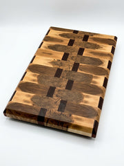 End Grain wooden cutting board with a geometric pattern of Maple and African Sapele showing the light and dark wood grains, photographed on a clean white background.