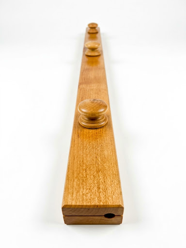 Alder quilt hanger is a clamp-style hanger that won't damage your quilt, with round wooden knobs and visible wood grain on a white background.