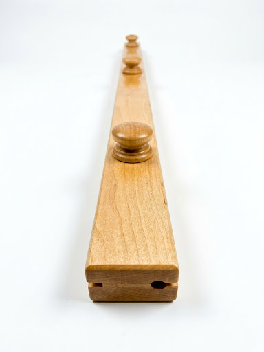 Birch quilt hanger is a clamp-style hanger that won't damage your quilt, with round wooden knobs and visible wood grain on a white background.